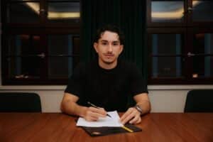 Jason Ceka in Dynamo-Dresden-Trikot, lächelnd mit Rückennummer 7, Stadionhintergrund.