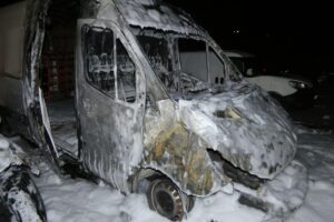 Ausgebrannte Fahrzeuge auf Parkplatz, Feuerwehr im Einsatz, Zeugensuche nach Brandstiftung.