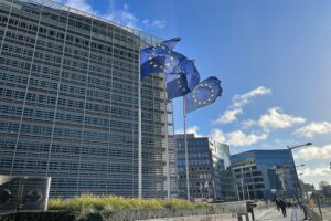 EU-Fahnen wehen im Wind, Symbol für Zusammenarbeit und aktuelle Herausforderungen in Europa.