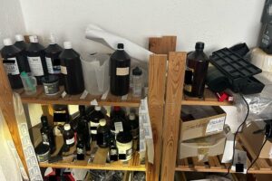 Lagerregal mit E-Zigaretten-Liquid, Behältern und Dosierspritzen, zur illegalen Herstellung.