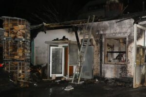 Abgebrannte Lagerhalle mit sichtbaren Brandschäden nach einem Feuer auf Firmengelände in Hagen.