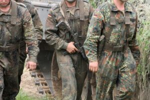 Nato-Soldaten und militärische Technologie symbolisieren die geplante Aufrüstung an Russlands Grenze.