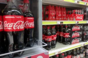 Coca-Cola-Produkte im Supermarktregal, symbolisieren steigenden Zuckerkonsum und Gesundheitsrisiken in Deutschland.