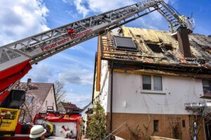 Drehleiter im Einsatz, Feuerwehrlöscharbeiten am Wohnhausbrand in Böblingen, Rauchaustritt sichtbar.