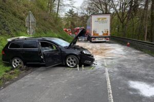 Unfallaufnahme: Schwer beschädigter Pkw und Lkw mit ausgelaufenem Diesel auf der Straße.