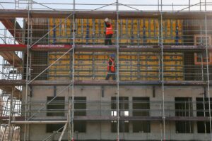 Bauarbeiter auf Baustelle, symbolisiert rückläufigen Wohnungsbau und sinkende Fertigstellungszahlen in Deutschland.