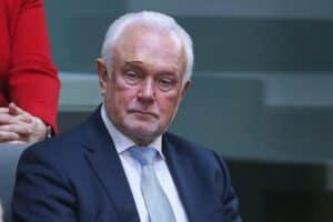 Wolfgang Kubicki steht vor dem Bundestag, umgeben von skeptischen Bürgern und Umfrageergebnissen.