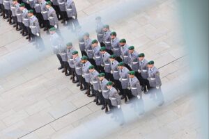 Bundeswehrsoldaten in Uniform, stolz und entschlossen, auf einem militärischen Gelände in Berlin.