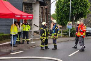 Feuerwehrkräfte sichern Gastank, während Anwohner evakuiert und Straßen gesperrt sind.